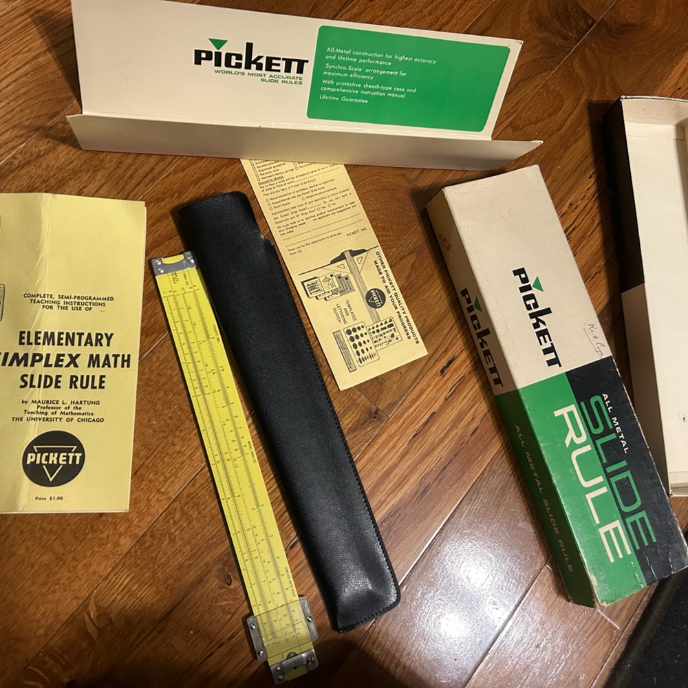 Vintage all metal slide rule with instructions and original box.